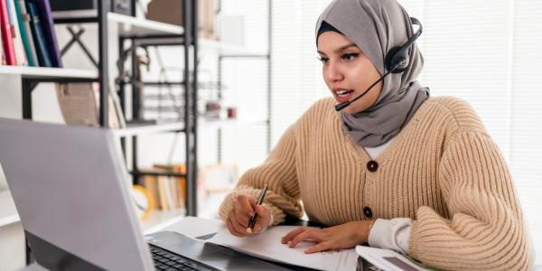 Business person with headset answering customer service calls.