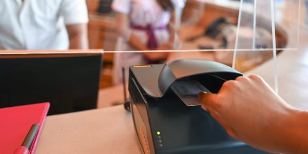 Person scanning id card on electronic scanner.