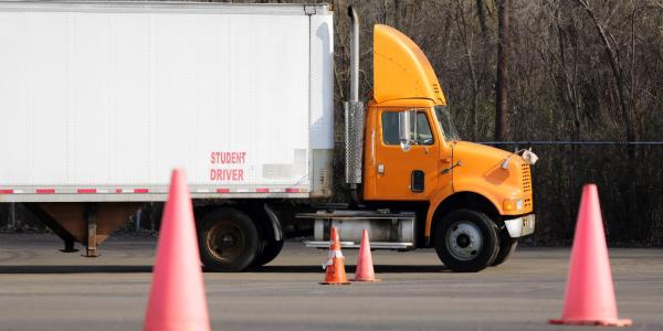 Student truck driver training on parking maneuvers.