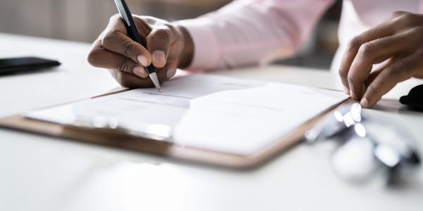 Person signing legal document.