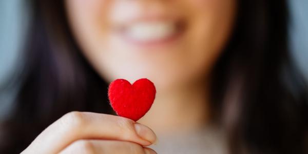 Person holding a tiny heart.